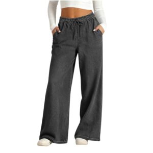 Damenbaggy jeans mit hohem Bund und weitem Bein in einem neutralen Graustich. Das Modell tritt auf einem weißen Hintergrund auf und trägt weiße Schuhe. Die Jeans haben einen weiteten Beinabschnitt und ein Gummiband an der Seite.