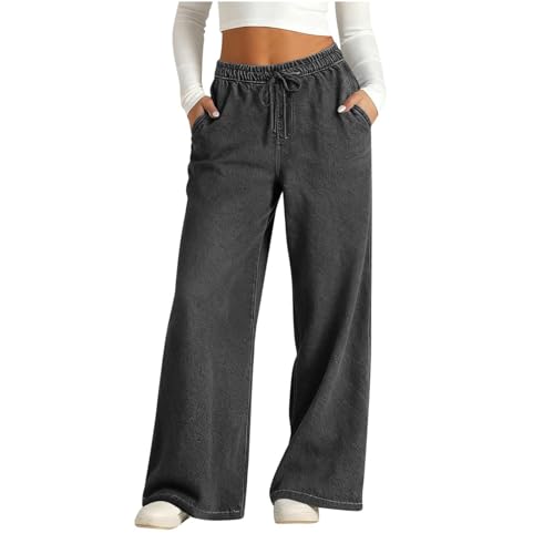 Damenbaggy jeans mit hohem Bund und weitem Bein in einem neutralen Graustich. Das Modell tritt auf einem weißen Hintergrund auf und trägt weiße Schuhe. Die Jeans haben einen weiteten Beinabschnitt und ein Gummiband an der Seite.
